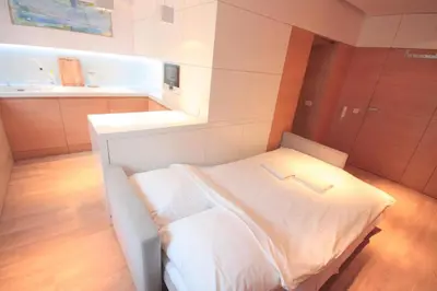 a bedroom with a white bed in a room at Modern & Resto Apartments in Kraków