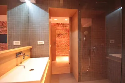a bathroom with a shower and a sink and a tub at Modern & Resto Apartments in Kraków
