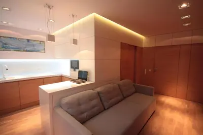 a living room with a couch in a kitchen at Modern & Resto Apartments in Kraków