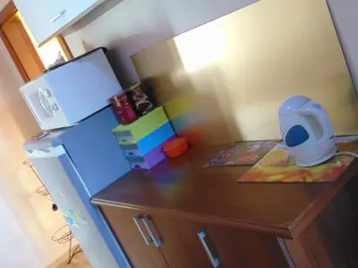 a toy kitchen with a counter and a refrigerator at POD RÓŻĄ in Kasina Wielka