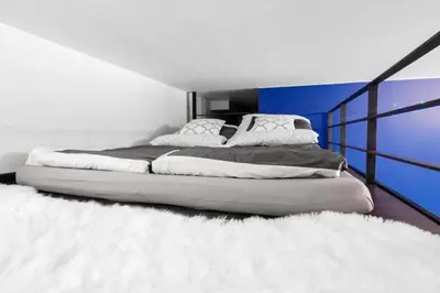 a bedroom with a large bed with a white blanket at Room Tour Lubomirskiego 23 in Kraków