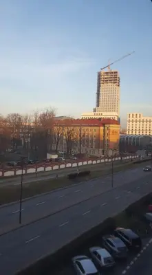 a highway with cars parked in front of a building at Room Tour Lubomirskiego 23 in Kraków