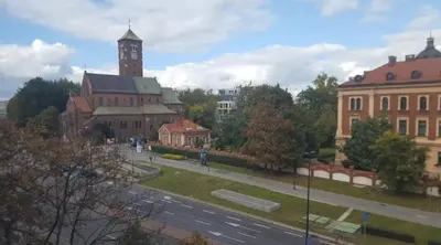 a view of a city with a clock tower and a street at Room Tour Lubomirskiego 23 in Kraków