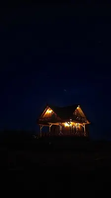 a lit up building with lights in the dark at Hamajdówka in Zubrzyca Górna
