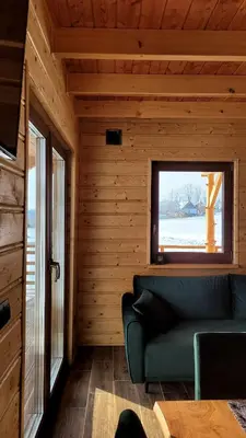 a living room with a couch and a window at Hamajdówka in Zubrzyca Górna