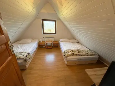 a room with two beds in a attic at Spacerowy Zakątek in Ślemień