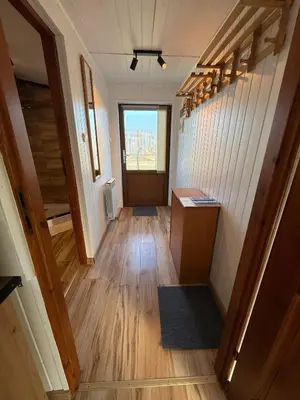 an empty hallway with a door in a house at Spacerowy Zakątek in Ślemień