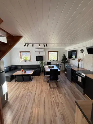 a living room with a couch and a table at Spacerowy Zakątek in Ślemień