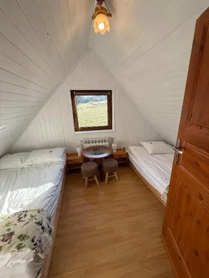 a room with two beds and a table in a tent at Spacerowy Zakątek in Ślemień