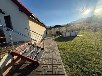 a shopping cart sitting on the side of a house at Spacerowy Zakątek in Ślemień