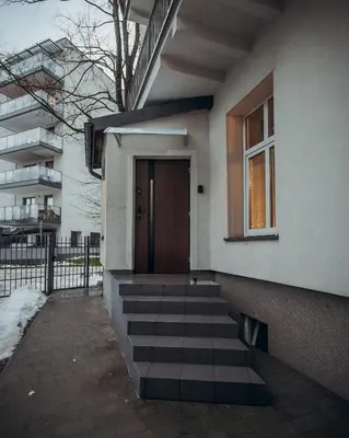 a building with a door and stairs leading to it at RELAX APARTMENT (Netflix, PS4, fotel masujący) in Kraków