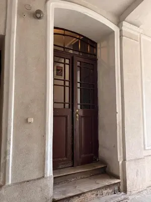 an entrance to a building with a brown door at Appartement Vieille Ville in Kraków