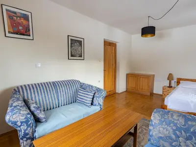 a living room with a couch and a table at Apartamenty w Gorcach in Nowy Targ