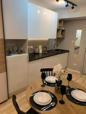 a kitchen with a table with two plates on it at Petit Appartement in Kraków