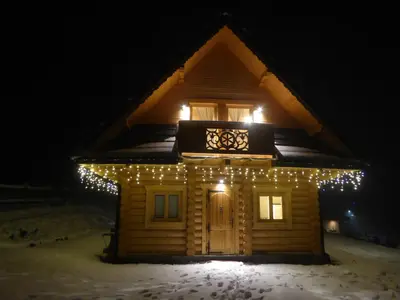 a house with christmas lights on it at night at Sielsko Anielsko in Stryszawa