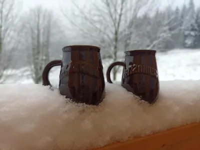 two vases sitting on a ledge covered in snow at Sielsko Anielsko in Stryszawa