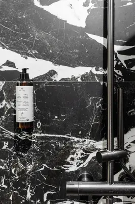 a bottle of soap sitting on top of a marble counter at Apartamenty Jubilat - KRK FOR STAY in Kraków