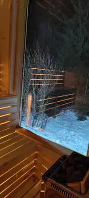 a view of a window with snow on the ground at Oskarówka domek w górach na odludziu z jacuzzi i sauną - kominek i Netflix in Szczawa