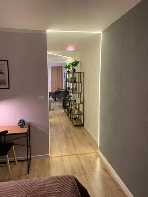 a room with a hallway with a table and a room with a table at Moderno Apartament in Kraków