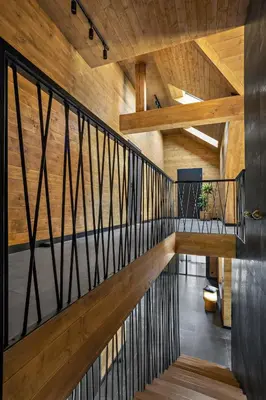 a staircase in a house with wooden walls and ceilings at Chillout Ślemień nowoczesny dom w górach in Ślemień