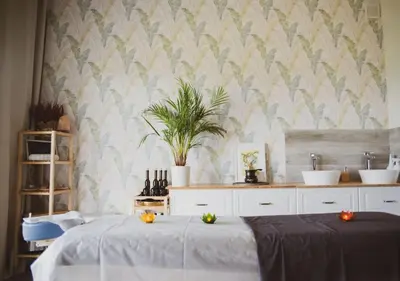 a bedroom with two beds and a plant on the wall at Bliżej Nieba in Skrzydlna