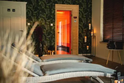 a room with a couch and a wall with plants at Bliżej Nieba in Skrzydlna