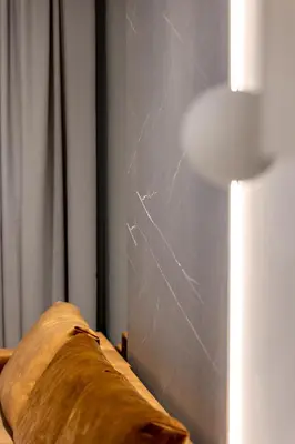 a spiderweb on a wall next to a pillow and a lamp at Republiki Korczakowskiej Apartamenty in Kraków