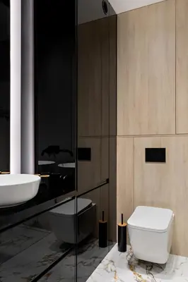 a bathroom with a white toilet and a sink at Republiki Korczakowskiej Apartamenty in Kraków