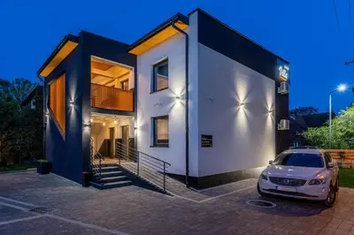 a car parked in a parking lot in front of a house at Villa Sol in Oświęcim