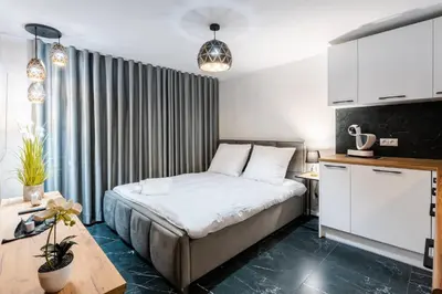 a hotel room with a bed and a table at Villa Sol in Oświęcim