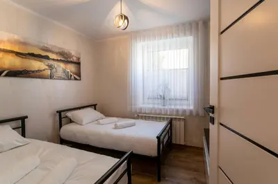 two beds in a small room with a window at Villa Sol in Oświęcim