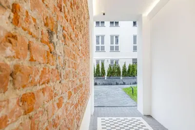 an open hallway with a brick wall at Czarnowiejska 21A by Homeprime in Kraków