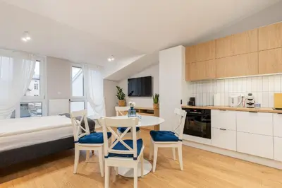 a room with a bed and a table and chairs at Czarnowiejska 21A by Homeprime in Kraków