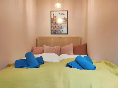 a bed with blue pillows on top of it at Czarnowiejska 21A by Homeprime in Kraków