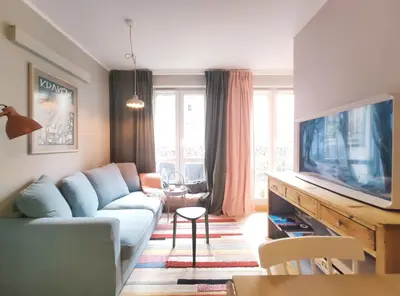 a living room with a couch and a tv at Czarnowiejska 21A by Homeprime in Kraków