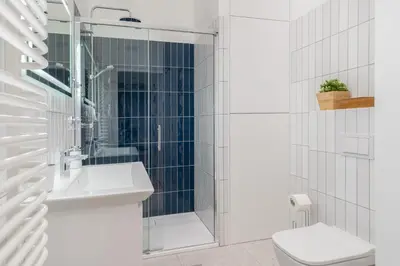 a bathroom with a shower and a toilet and a sink at Czarnowiejska 21A by Homeprime in Kraków