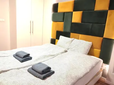 a bed with two towels sitting on top of it at Szafrana 5B by Homeprime in Kraków