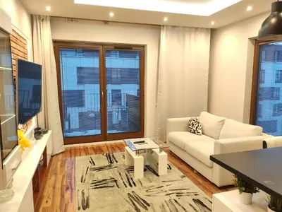 a living room with a couch and a table at Szafrana 5B by Homeprime in Kraków
