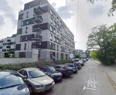 a row of cars parked in front of a building at Szafrana 5B by Homeprime in Kraków