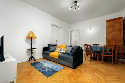 a living room with a couch and a table at Apartament blisko Wawelu in Kraków