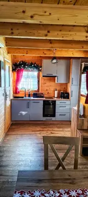a microwave sitting on top of a wooden counter at POD STARĄ PODKOWĄ komfortowy domek z kominkiem in Limanowa