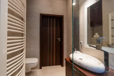 a bathroom with a sink and a toilet and a mirror at Luna Prestige Suite - Old Town Center & Main Station in Kraków