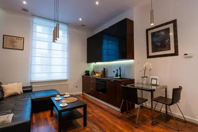 a living room with a couch and a table at Luna Prestige Suite - Old Town Center & Main Station in Kraków