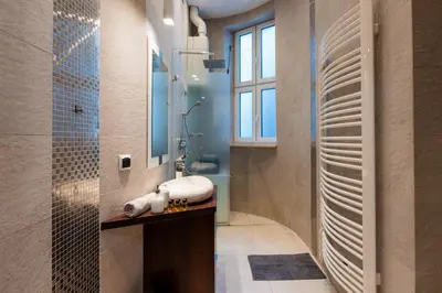 a bathroom with a sink and a shower at Luna Prestige Suite - Old Town Center & Main Station in Kraków