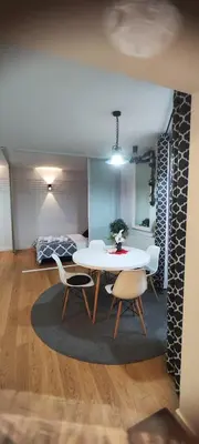 a living room with a white table and chairs at CHILLOUT APARTMENT SAREGO in Kraków