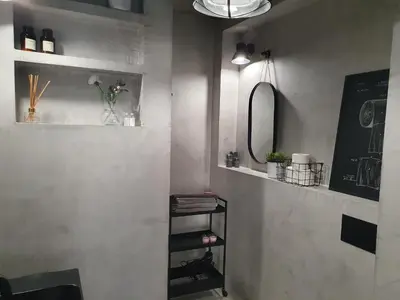 a bathroom with a mirror and a shelf with flowers at Fly_to_Cracow_14 in Kraków