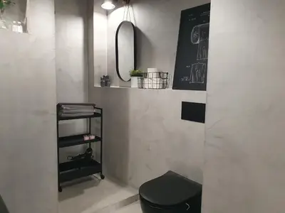 a bathroom with a black toilet and a mirror at Fly_to_Cracow_14 in Kraków