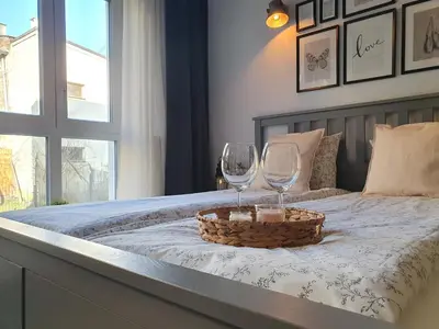 a bed with two wine glasses and a basket on it at Fly_to_Cracow_14 in Kraków