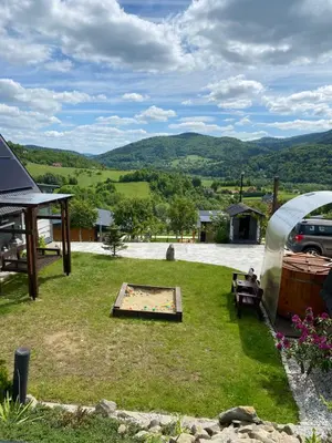 a backyard with a picnic table and a tent at Domki- Limanowa, domki z balią i sauną in Limanowa