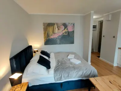 a bedroom with a bed and a painting on the wall at Hugo VIP Apartments in Kraków